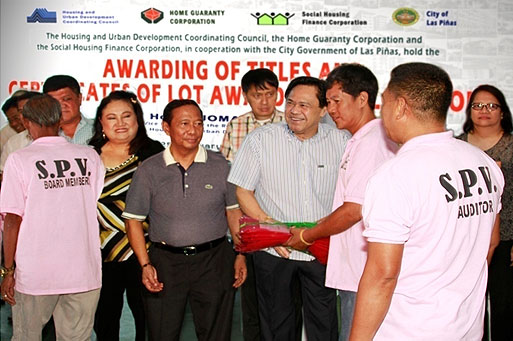 Vice President and HUDDC Chairman Jejomar C. Binay and HGC President Atty. Manuel R. Sanchez award the CoLAs and CELAs to members of the Sambayanihan People’s Village, Inc. in Las Piñas City.